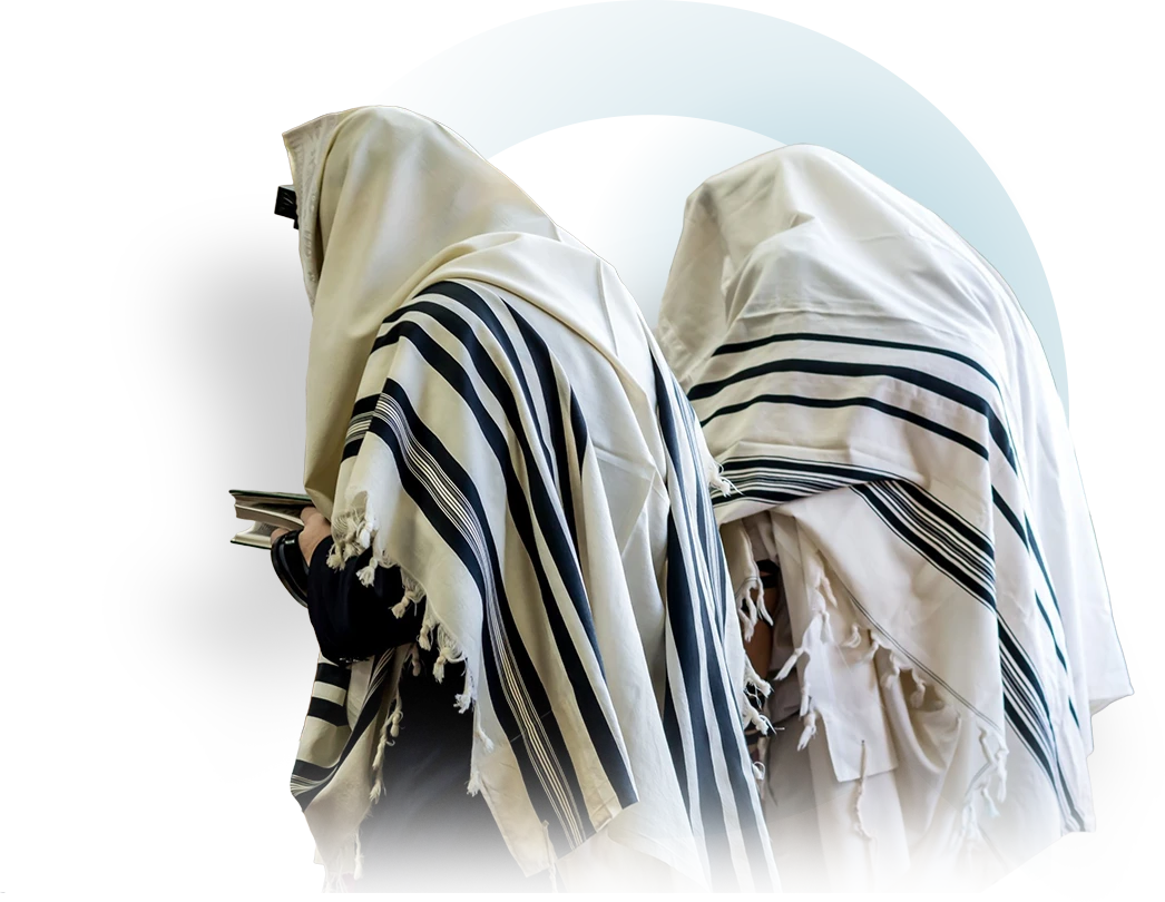 Two men standing in prayer under their tallitot